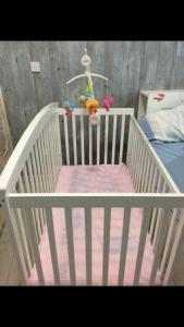 Baby cot with mattress and bed sheets