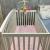 Baby cot with mattress and bed sheets